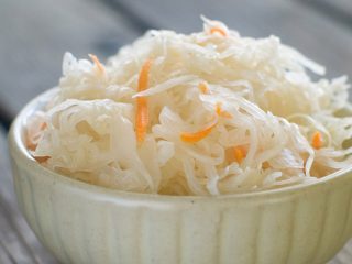 Pickled cabbage with garlic, butter and carrots
